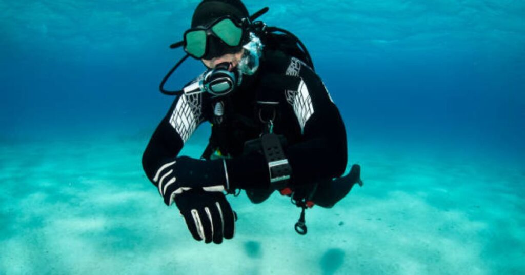 Scuba diver checking their dive computer for safety during a dive