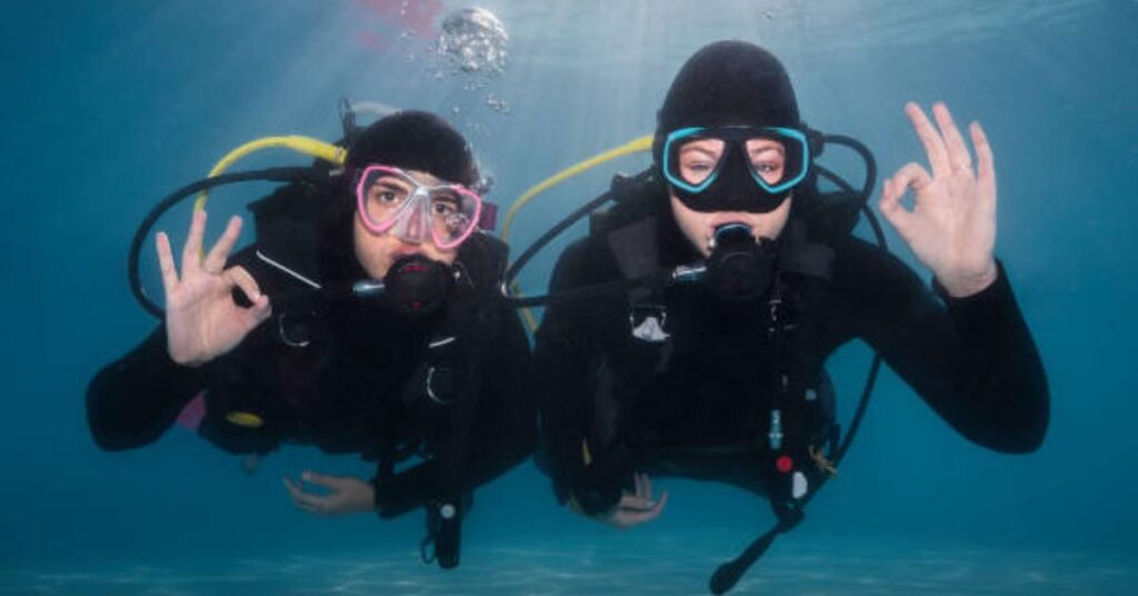 Diver pointing direction with a hand signal underwater