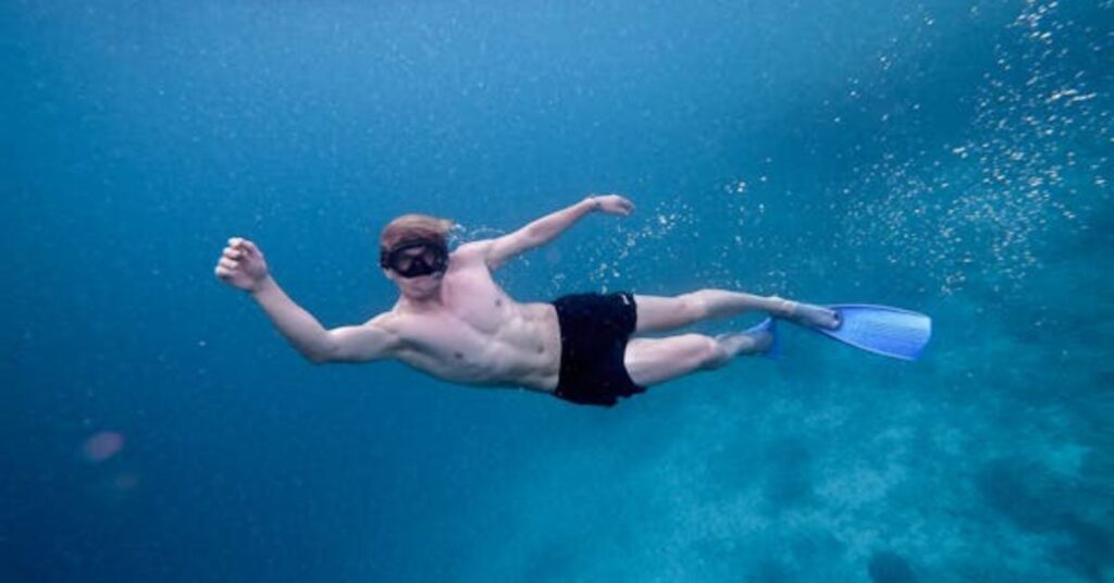 Diver signaling low air supply during a scuba dive
