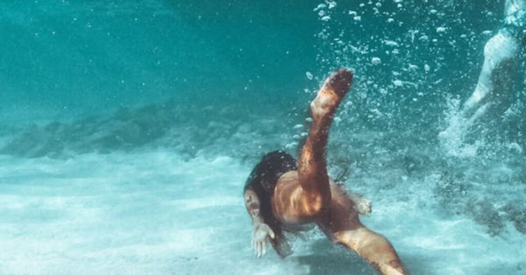 Diver signaling feeling cold with crossed arms gesture