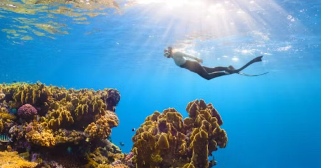 Beginner practicing swimming skills for scuba diving in a pool