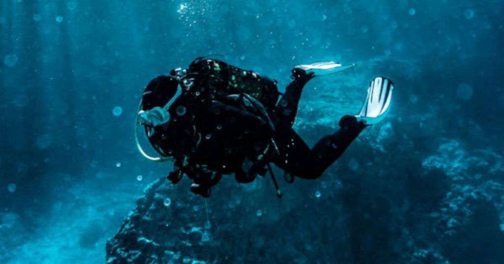 Scuba divers performing a buddy check – Scuba Diving Acronyms
