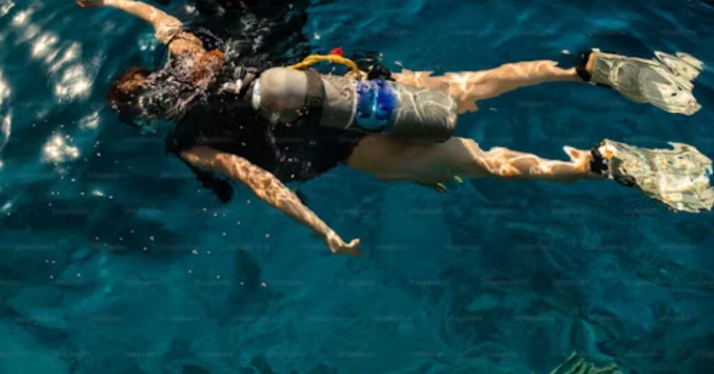 Beginner learning how to prepare for scuba diving with an instructor